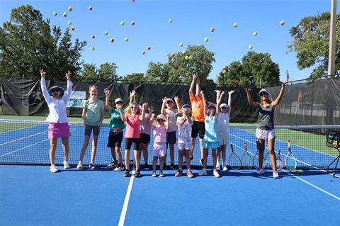 Kids throwing tennis balls