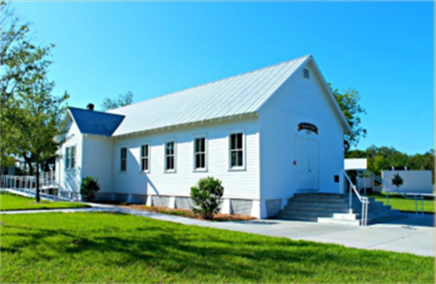 White Building with sidewalks and grass surroundings