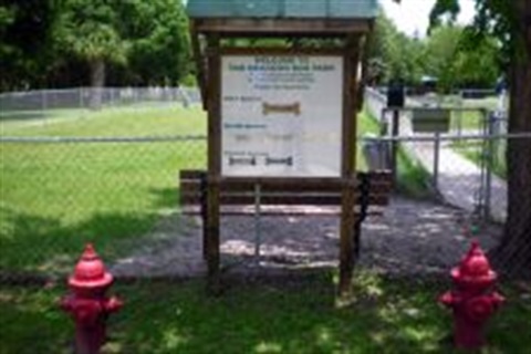 Dog park with sign and fire hydrants