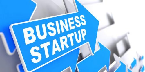 Blue arrows pointing to the right saying business start up in white text.